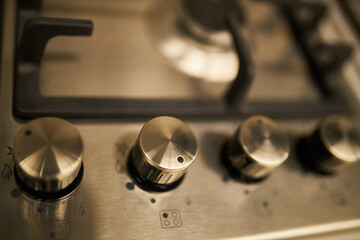 White / black / electric stove close-up switch. Close-up of the knob of the switch of a gas stove. Close-up white / black electric stove control knobs. Soft focus.
