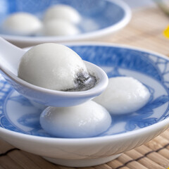 Close up of tangyuan in a bowl on gray table, food for Winter Solstice.