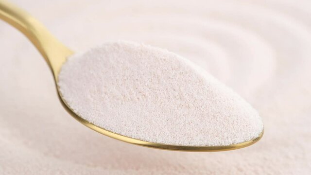 collagen powder in golden spoon and collagen powder background rotating. Natural beauty and health supplement