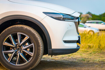 Front side exterior fragment of modern SUV outdoor view