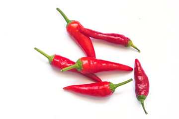 green and red hot chili peppers on a white background. 