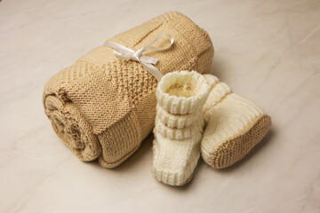 Homemade kniteed newborn paid on light background