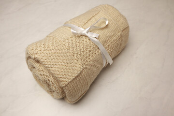 Homemade kniteed newborn paid on light background