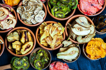 Organic Healthy Assorted Dried Fruit Mix close up. Dried fruit snacks. dried apples, mango, feijoa, dried apricots, prunes top view