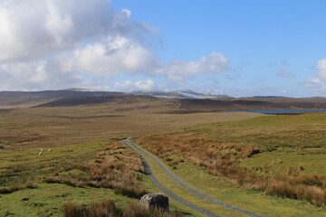 A lonely track across high moorland to Glaslyn bird watching nature reserve near Dylife in Wales, UK.