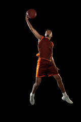 High. Young purposeful african-amrican basketball player training, practicing in action, motion...
