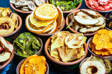 Organic Healthy Assorted Dried Fruit Mix close up. Dried fruit snacks. dried apples, mango, feijoa, dried apricots, prunes top view
