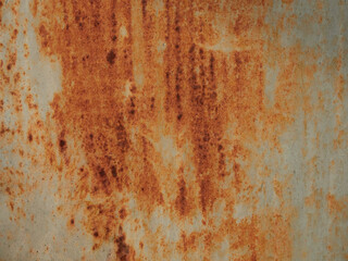 Rust.Old blue painted wall with rust spots.Textured rusty metal background. Rust stains through the cracked blue paint.