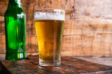 Beer mugs and beer bottles on a wooden table