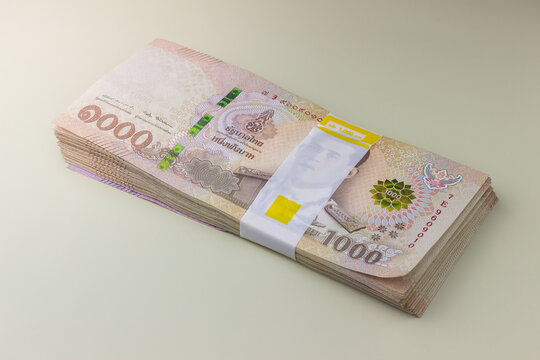 stack of Thai Baht money on beige background, hundred thousands