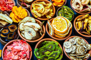 Organic Healthy Assorted Dried Fruit Mix close up. Dried fruit snacks. dried apples, mango, feijoa, dried apricots, prunes top view