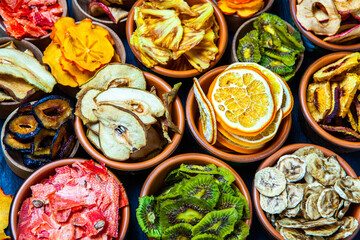 Organic Healthy Assorted Dried Fruit Mix close up. Dried fruit snacks. dried apples, mango, feijoa, dried apricots, prunes top view