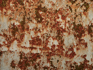 Rust.Old blue painted wall with rust spots.Textured rusty metal background. Rust stains through the cracked blue paint.