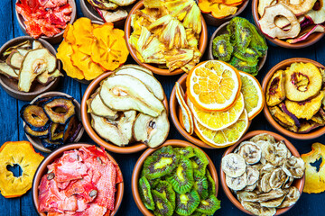 Organic Healthy Assorted Dried Fruit Mix close up. Dried fruit snacks. dried apples, mango, feijoa, dried apricots, prunes top view
