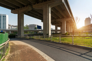Concrete structure and asphalt road space under the overpass in the city