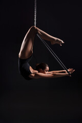 A female gymnast on an air ring (hoop)