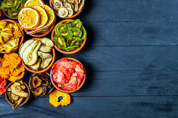 Organic Healthy Assorted Dried Fruit Mix close up. Dried fruit snacks. dried apples, mango, feijoa, dried apricots, prunes top view