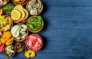 Organic Healthy Assorted Dried Fruit Mix close up. Dried fruit snacks. dried apples, mango, feijoa, dried apricots, prunes top view