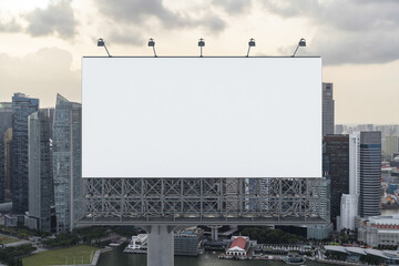 Obraz premium Blank white road billboard with Singapore cityscape background at sunset. Street advertising poster, mock up, 3D rendering. Front view. The concept of marketing communication to sell idea.