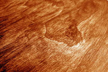 Naklejka premium Wooden board texture with blur effect in orange tone.