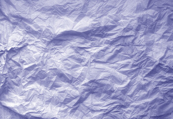 Crumpled blue paper sheet surface.