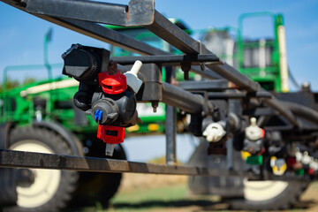 replaceable sprayer of a field high-clearance sprayer on a hinged boom - obrazy, fototapety, plakaty