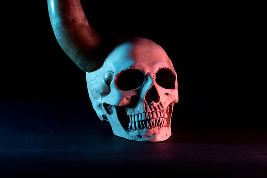 Human skull with a horn. Skull with a horn side view.