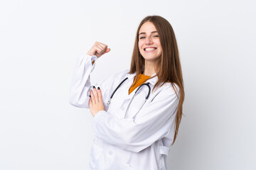 Young woman over isolated background wearing a doctor gown and making strong gesture