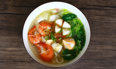 Tom yam soup on wood background.