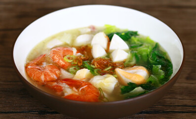 Tom yam soup on wood background.