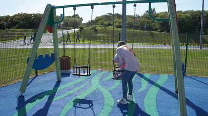 mother with a child on the Playground