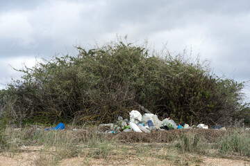 Garbage spilled in a natural setting. Empty dirty plastic bottles. Environmental pollution....