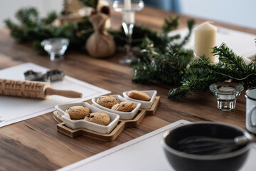 Christmas table decoration. Cookies in a herringbone-shaped plate. Festive atmosphere at home
