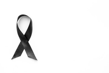Black awareness ribbon isolated on a white background. Top view