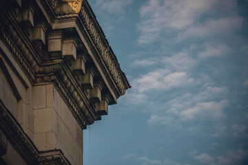 A beautiful old building. Classical architecture on the background of a blue cloudy sky
