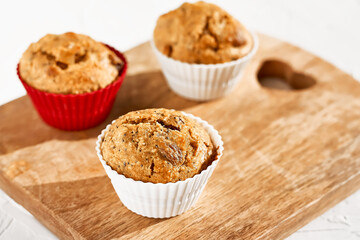 Homemade muffins with ginger and nuts on white table. Healthy eating, gluten free.Homemade tasty dessert or breakfast for Valentine's day,Mother's day