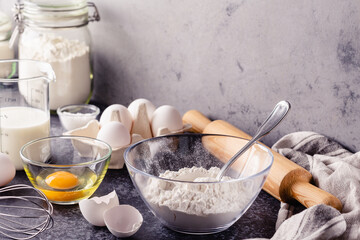 Cooking ingredients for dough, eggs, flour, sugar, milk.