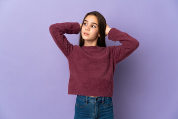 Little girl isolated on purple background frustrated and covering ears