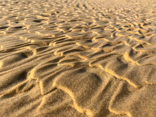 Wave patterns on the beach sand in close-up