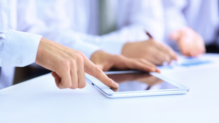 Obraz na płótnie Canvas business man with a digital tablet analyzing a financial chart.