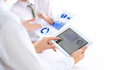 business man with a digital tablet analyzing a financial chart.