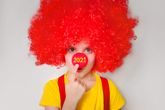 Numbers 2021 on the red nose of a clown. Holidays, party, concept. New year is coming.