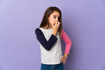 Little girl isolated on purple background having doubts