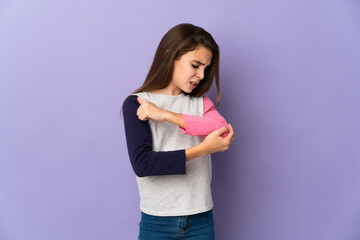 Little girl isolated on purple background with pain in elbow