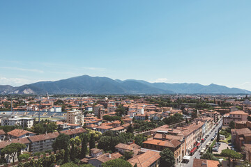 Fototapeta na wymiar Panoramic view of Pisa city with historic buildings and far away mountains