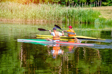 Two men floating in a canoe on the river
