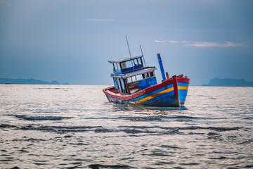 Shipwreck of fish boat at sunset in Thailand