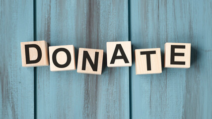 Donate text on a wooden blue background