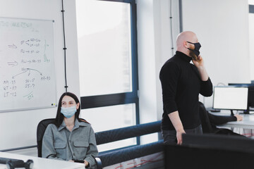 Office workers wearing protective masks