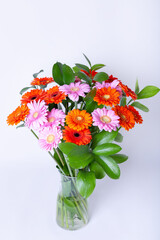 Bouquet of gerberas. Pink, Orange and Red gerbera on a white background. Close-up.